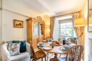 a dining room with a table and a couch at 3 Bed in Askrigg oc-ds779 in Askrigg +18 photos