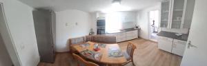 a kitchen with a table and chairs in a room at Am Fuße des Zoller in Bisingen
