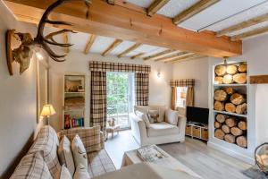 a living room with a couch and a table at 1 Bed in Callander oc-pe173 in Strathyre