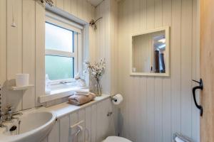 a bathroom with a sink and a toilet and a window at 1 Bed in Callander oc-pe173 in Strathyre +23 photos