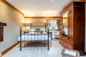 a bedroom with a bed and a desk and a window at 1 Bed in Callander oc-pe173 in Strathyre