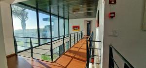 a hallway in a building with a glass wall at Exceptional villa in Vila Franca Do Campo with private pool in Vila Franca do Campo