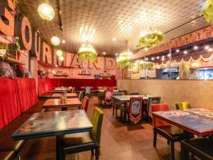 a restaurant with tables and chairs in a room at ibis Styles Tokyo Ginza in Tokyo
