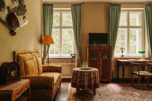 a living room with a couch and a chair at Villa Pepita in Miedzygorze