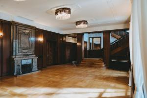 an empty room with a fireplace and a staircase at Villa Weisser Berg in Neuwied +20 photos