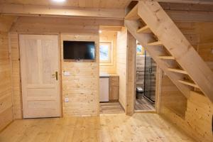 a log cabin with a staircase and a tv at Zlatarska dolina in Nova Varoš