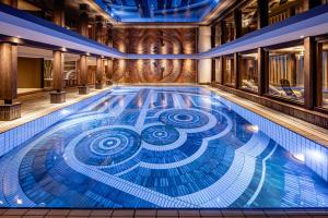 a swimming pool with a spiral design in the middle at Sporthotel Obereggen in Obereggen