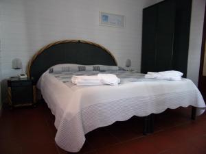 a bedroom with a large bed with towels on it at Hotel Fiascherino in Lerici