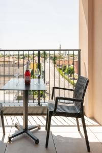 a table and chairs on a balcony with a view at DB Residence Luxury Stay in Noventa di Piave