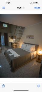 a bedroom with a large bed and a staircase at Ενοικιαζόμενα δωμάτια ΣΟΛΩΝΑΣ in Mytilene +4 photos