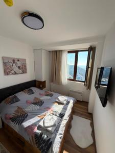 a bedroom with a bed and a large window at Gold Elegant & Spa Kop in Kopaonik +54 photos