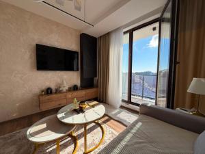 a living room with a couch and a table at Gold Elegant & Spa Kop in Kopaonik
