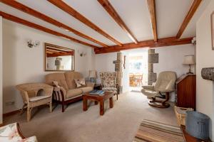 a living room with a couch and chairs at Mariners Cottage - Elie in Elie