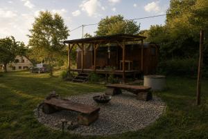 a backyard with a picnic table and a gazebo at Maringotka MIMO in Uhelná
