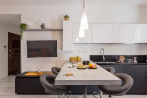 a kitchen with a table and chairs in a kitchen at The Apartment Trastevere - Ba.home in Rome