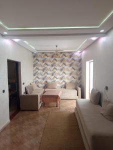 a living room with a couch and a table at Araucaria in Oualidia +33 photos