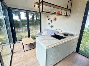 a kitchen with a sink and a counter top at Domki Machnice in Machnice +44 photos