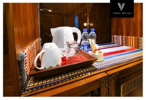 a counter with bottles of alcohol and a blender at Viridi Hotels Islamabad in Islamabad