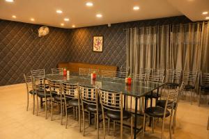 a conference room with a long table and chairs at Mansarover Hotel & Banquets in Bareilly
