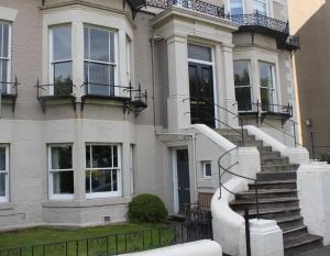 a house with a staircase in front of it at Collingwood House Tynemouth in Tynemouth