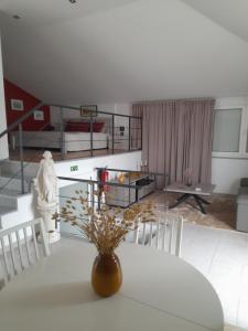 a living room with a table and chairs and a bedroom at cupido feeling nomad in Souro Pires