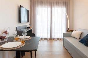 a living room with a table and a couch at DB Residence Luxury Stay in Noventa di Piave
