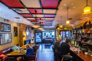 a group of people sitting at a bar in a restaurant at Horans Bar and Restaurant in Baltinglass +27 photos