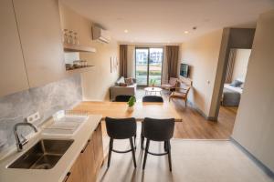 a kitchen with a sink and a living room at Letstay Marine Homes in Antalya