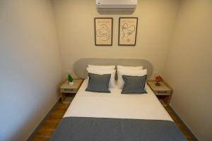 a small bedroom with a bed with two night stands at Letstay Marine Homes in Antalya
