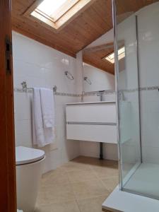 a bathroom with a toilet and a glass shower at Casa Vida Alegre in Prazeres