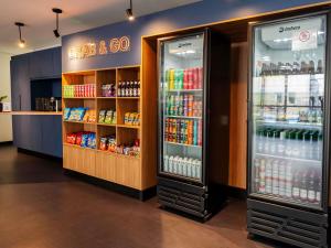 a grocery store with two refrigerators and drinks at Ibis Styles Campinas Alphaville in Campinas