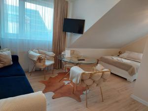 a bedroom with a bed and a table and chairs at Mirato in Władysławowo