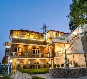 a large building with a staircase in front of it at The Palace by Boho Travelista in Bhīm Tāl +20 photos