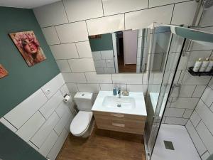 a bathroom with a sink and a toilet and a mirror at Suite Privada & Acogedora in Puerto del Rosario +2 photos