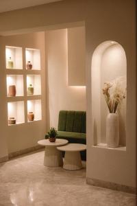 a living room with a green couch and a table at Hotel Donia Sfax in Sfax +44 photos