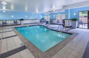 a pool in a hotel room with blue walls at Fairfield Inn & Suites Kodak in Kodak