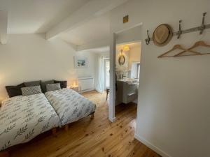 a bedroom with a bed and a bathroom with a sink at Chez Marie in Grignan