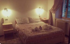 a bedroom with a bed with two pillows on it at Locanda San Nicolo - Sestola Centro in Sestola +4 photos