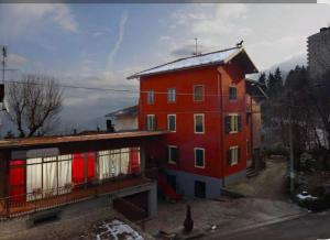 a large red building with red doors on a street at Locanda San Nicolo - Sestola Centro in Sestola