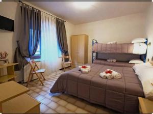 a bedroom with a bed with towels on it at Locanda San Nicolo - Sestola Centro in Sestola