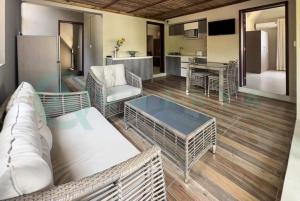 a living room with a couch and a table at Beachfront villa by M&H in Tamarin