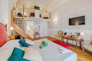 a living room with a bed and a staircase at Maison 31 - Unique Experience in Civitavecchia