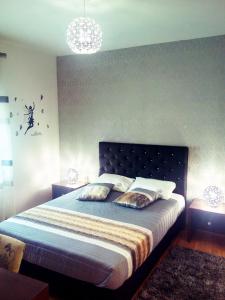 a bedroom with a bed and a chandelier at Casa do Azibo in Santa Combinha