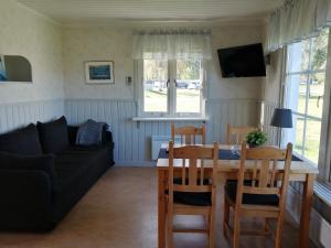 a living room with a table and a couch at Kukkolaforsen Turist & Konferens in Haparanda