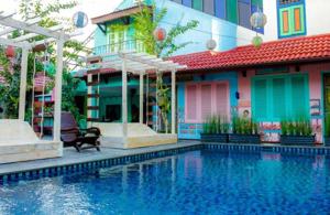 a house with a swimming pool in front of a building at Omah Njonja Bed & Brasserie in Yogyakarta