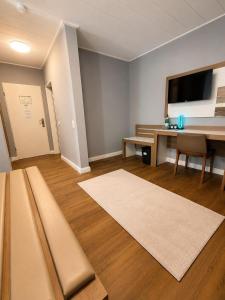 a living room with a couch and a table at Hotel Dortmund City in Dortmund