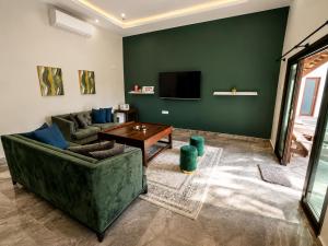 a living room with a couch and a table at Charis Tanjong Jara Villa Emerald in Dungun