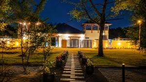 a pathway leading to a house at night at Charis Tanjong Jara Villa Emerald in Dungun