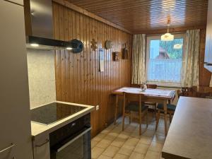 a kitchen with a table and a stove top oven at Haus Lüftleck in Lunz am See