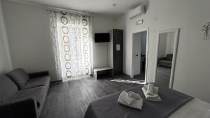 a bedroom with a bed and a couch and a mirror at Villa Flora in Pompei